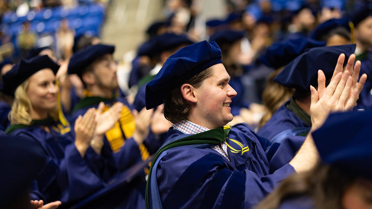 Graduates clapping in the crowd